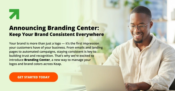 Man smiling as he works on a laptop, next to text reading ‘Announcing Branding Center: Keep Your Brand Consistent Everywhere’